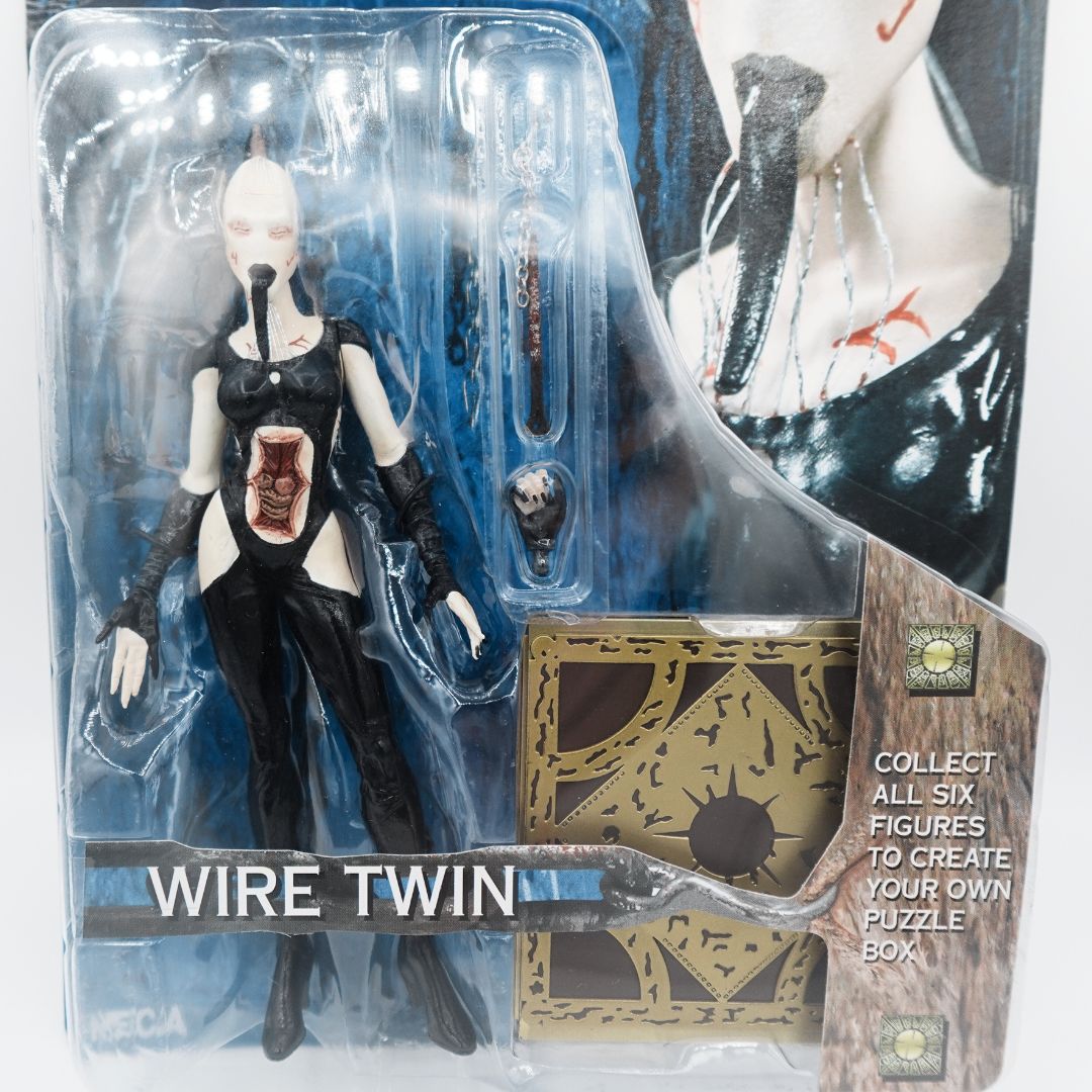 Close up of the Hellraiser Wire Twin action figure in packaging alongside puzzle piece and accessories