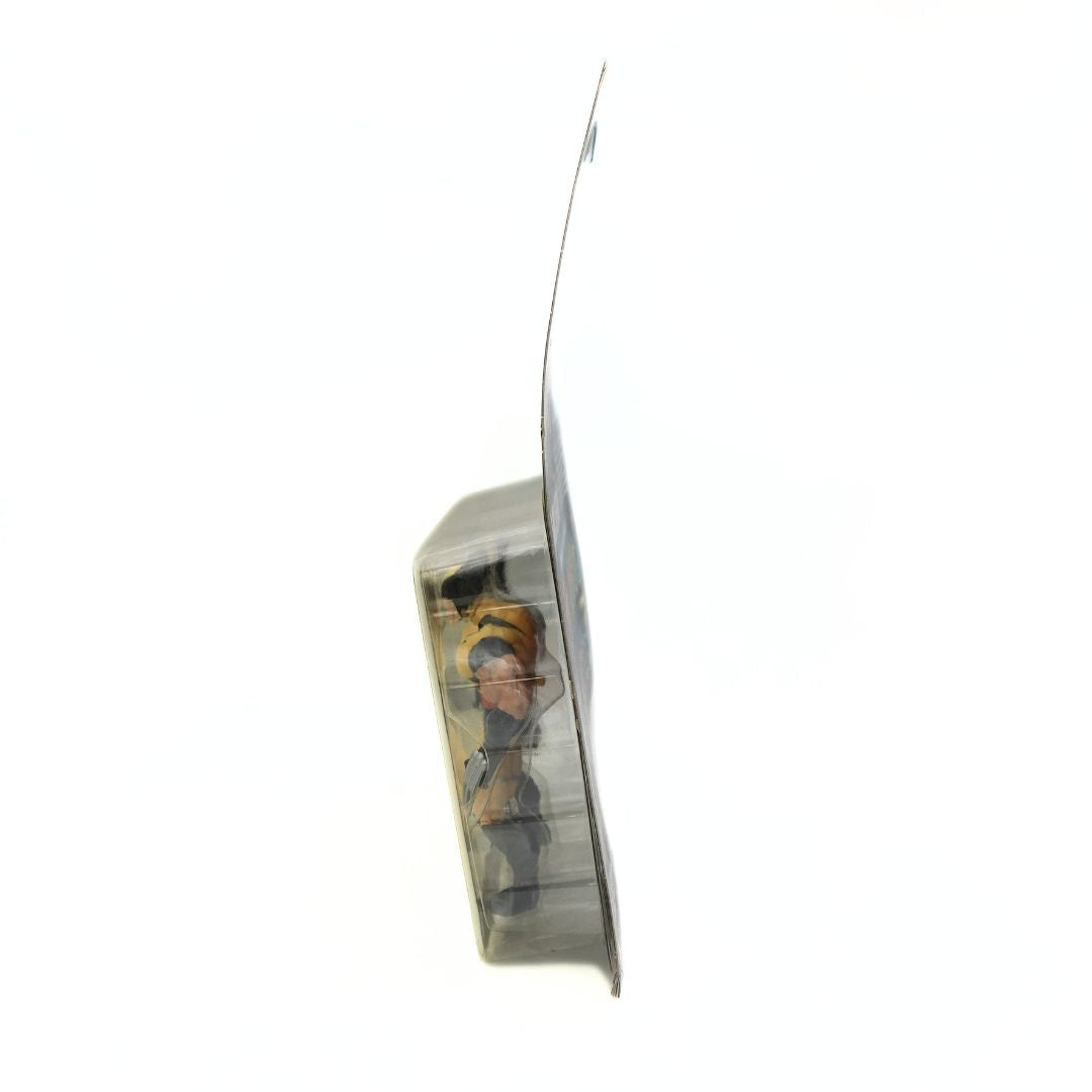 Side on photo of a 90s Wolverine figure in its packaging, showing warping to the cardboard