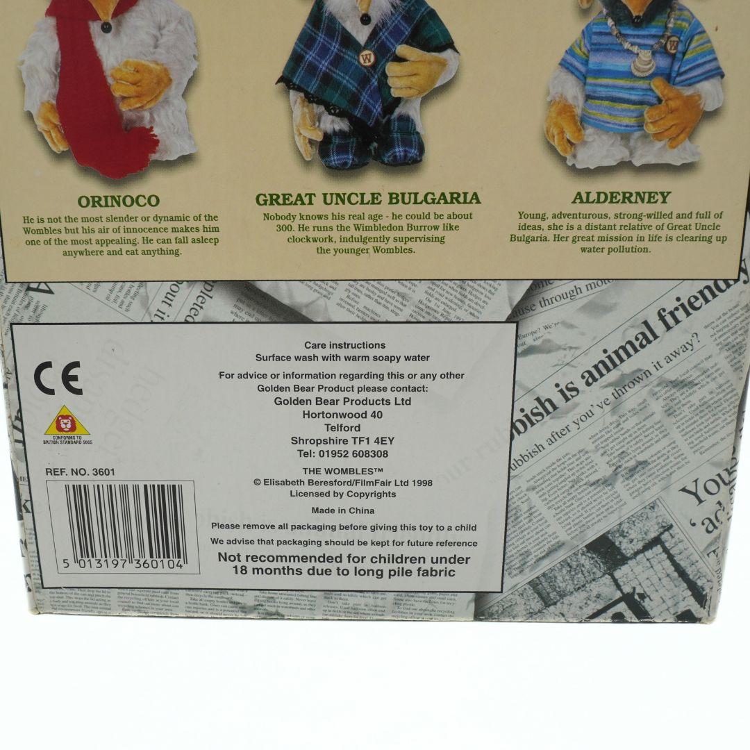 Back of a Wombles toy packaging with character illustrations and text.