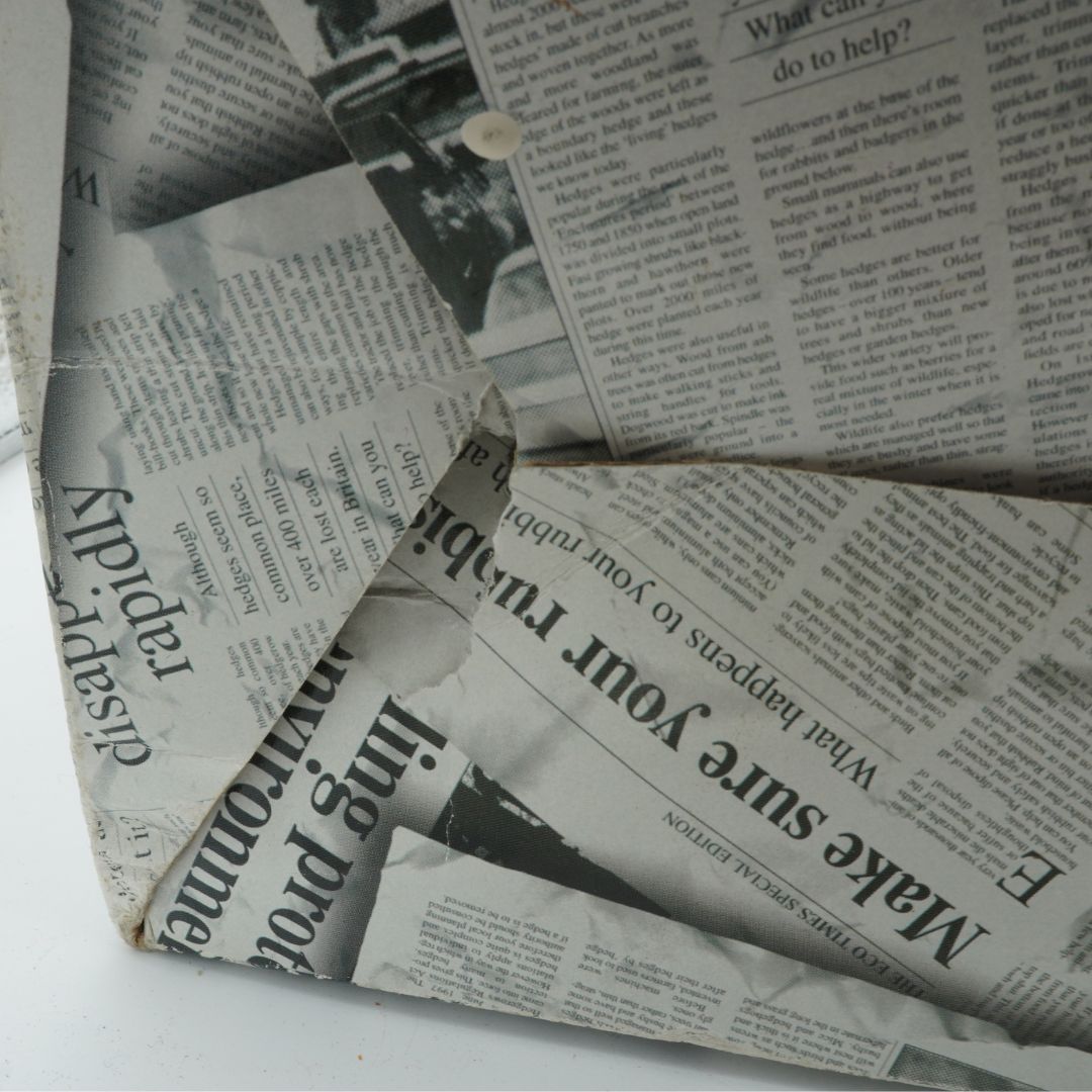 Cardboard box with a newspaper print design