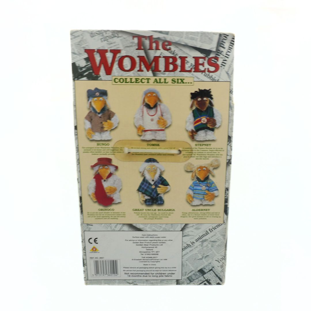 Packaging of 'The Wombles' collectible plush toys with images of the figures on a newspaper background.