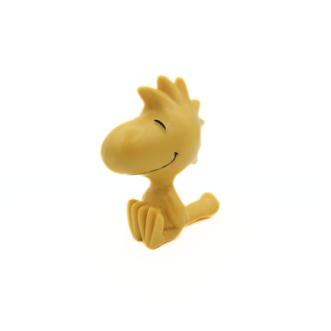 Small yellow figurine of Woodstock from Peanuts