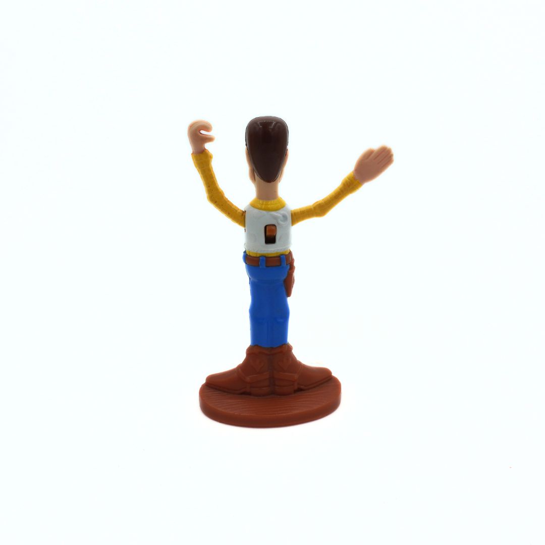 Toy figure of a character with arms raised on a white background