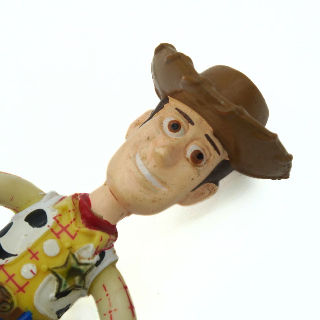 Toy Story figure of Woody with a cowboy hat on a white background