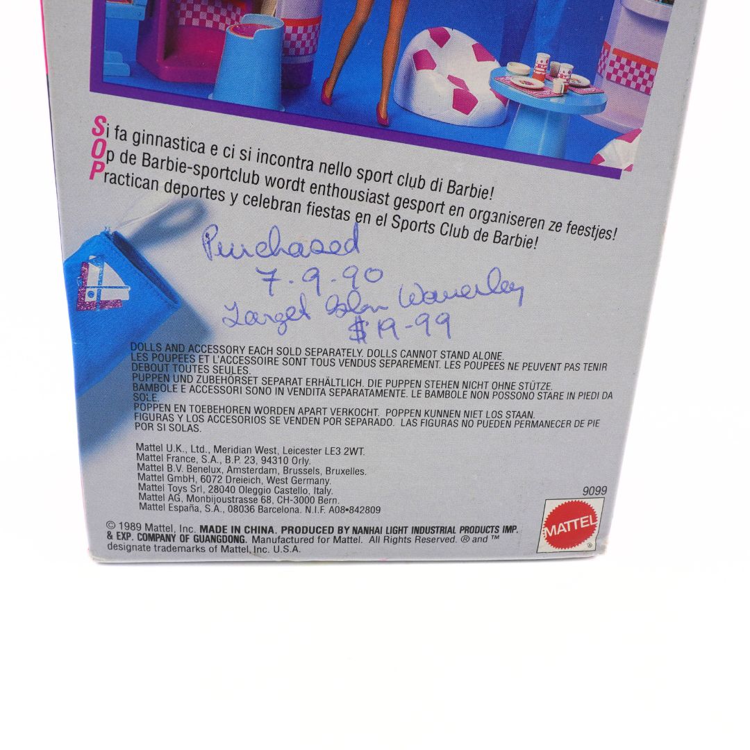 Back of a toy packaging with text and branding, featuring a small figure and furniture.