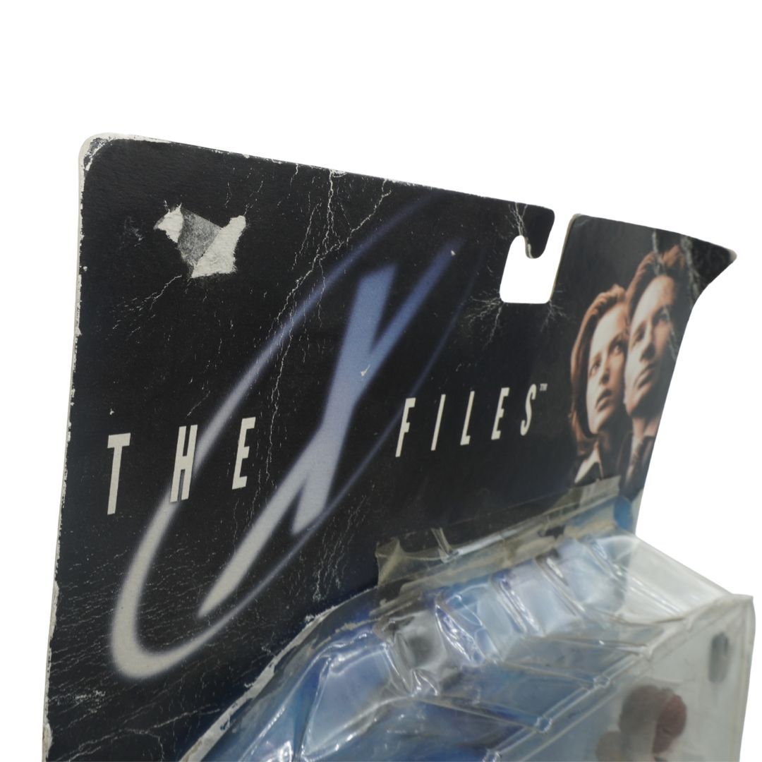 Action figure packaging for 'The X-Files' with character images on a black background.
