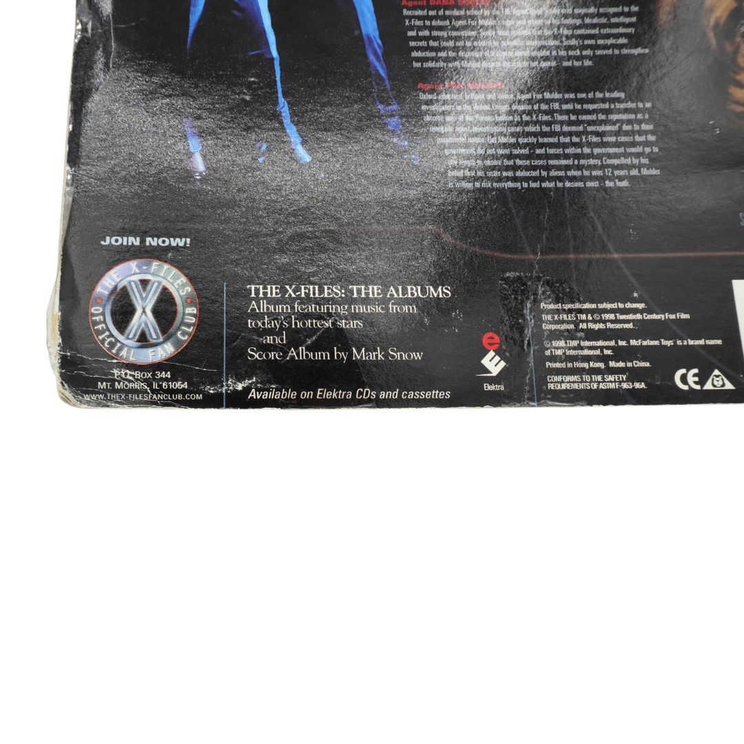Back cover of a 'The X-Files' toy with text and branding.