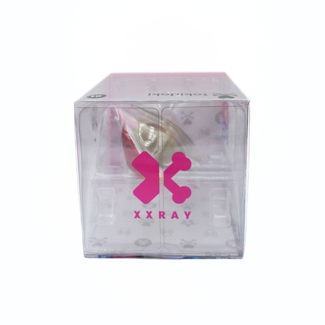 A Tokidoki XXRAY box, featuring a clear plastic container with a pink XXRAY logo and a unicorn visible inside.