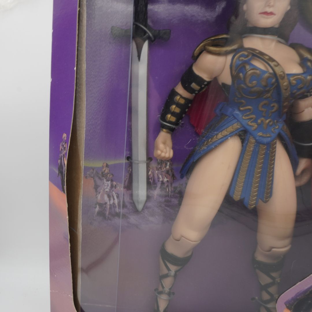 Creasing to the purple box holding a vintage 90s Xena figurine