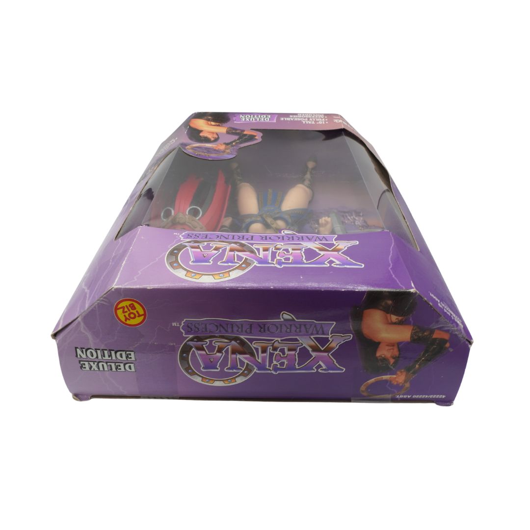Toy figure in a purple packaging box with visible branding on a white background