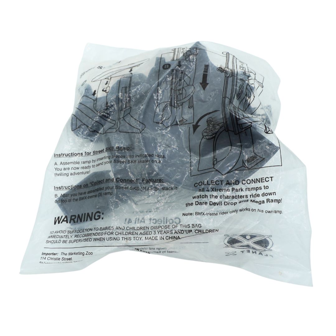 A sealed translucent plastic bag containing a toy set with printed assembly instructions and a warning label, photographed on a plain white background.