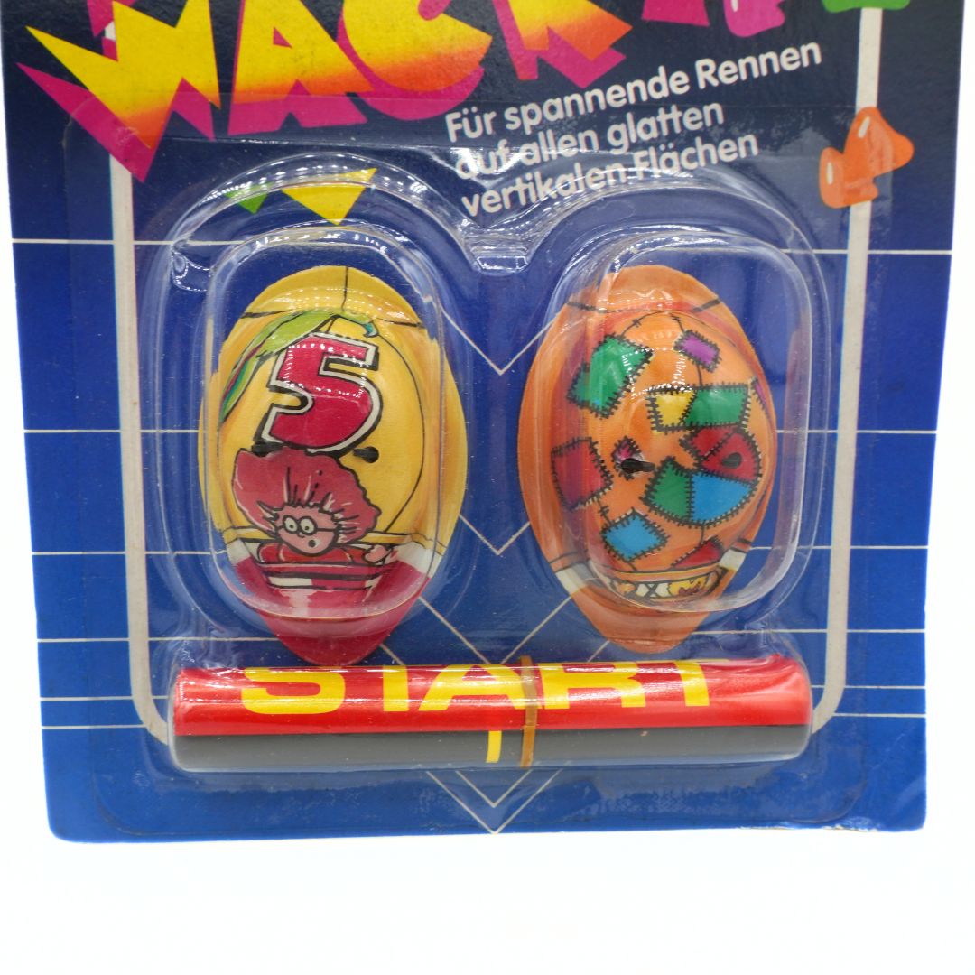 Two colorful plastic eggs with numbers and letters in a blue packaging