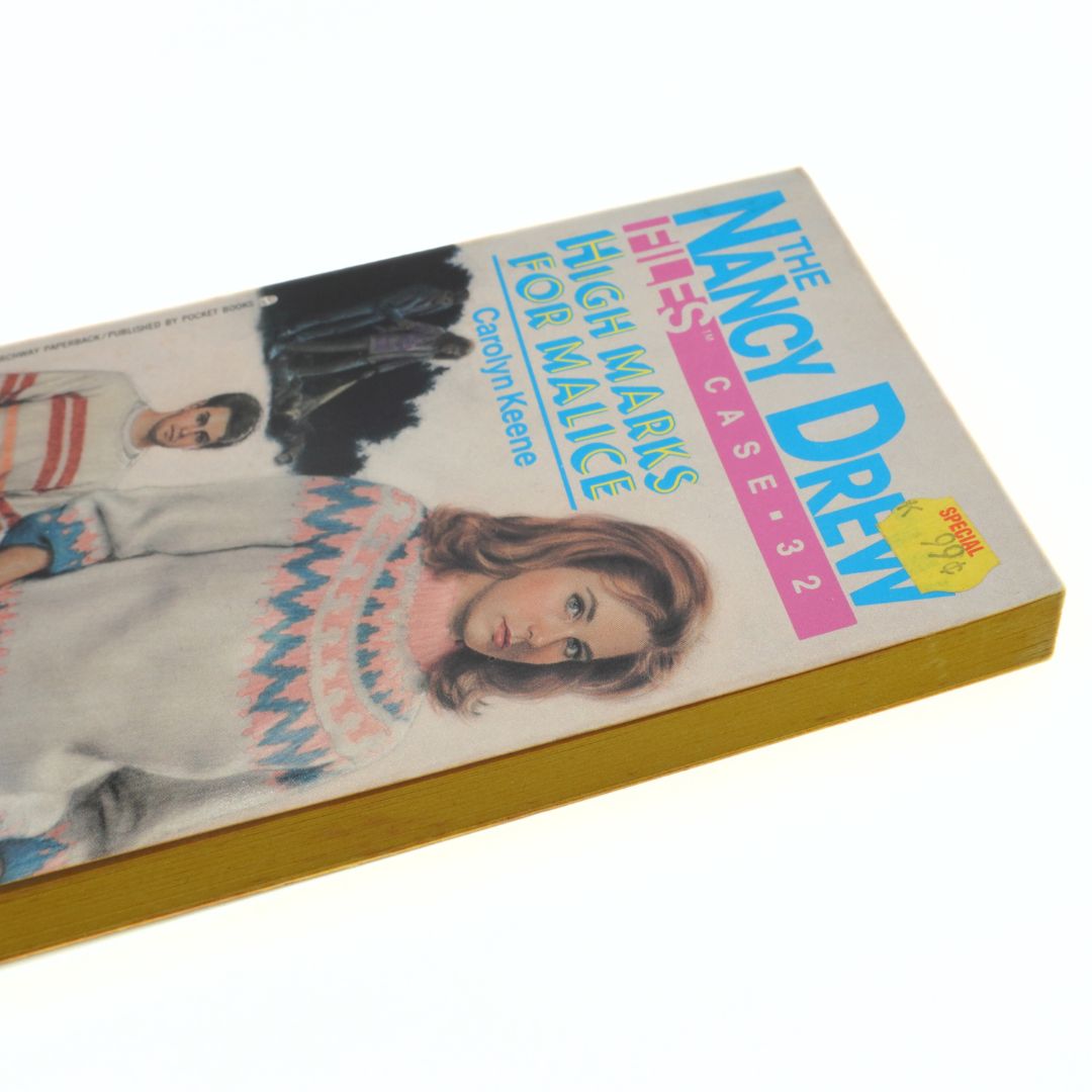 Vintage Nancy Drew book with a cover featuring a girl and a boy on a white background