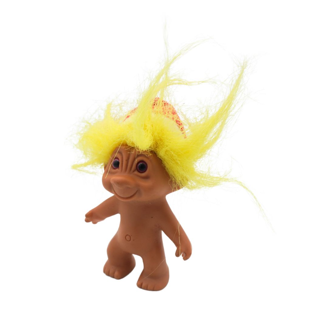 Toy figure with yellow hair on a white background