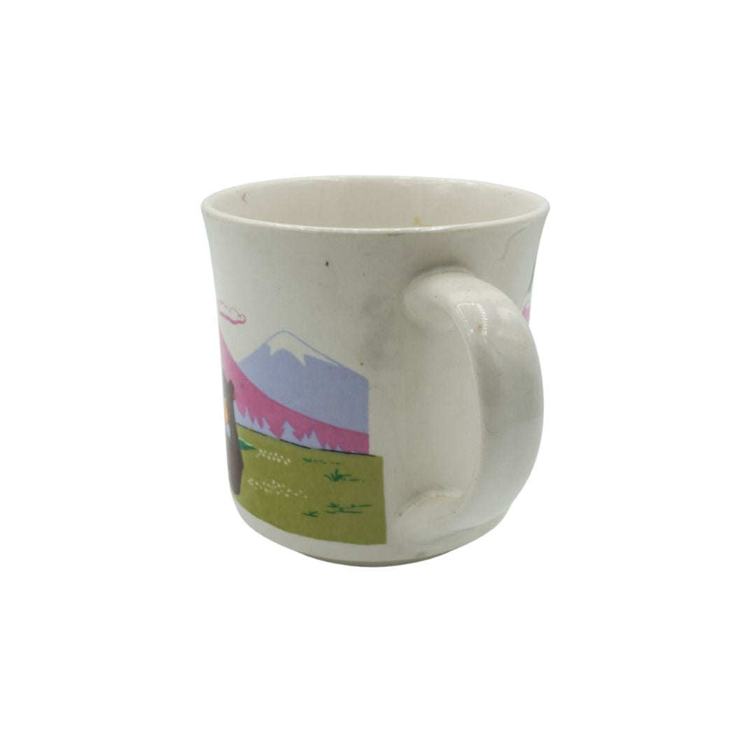 White mug with a scenic design on a white background