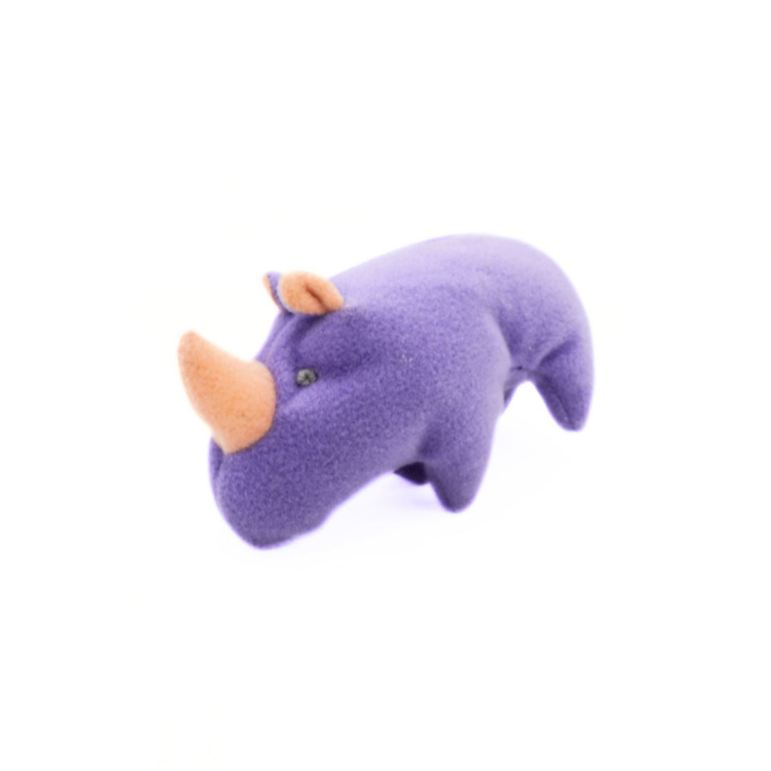 Purple rhinoceros plush toy on a white background