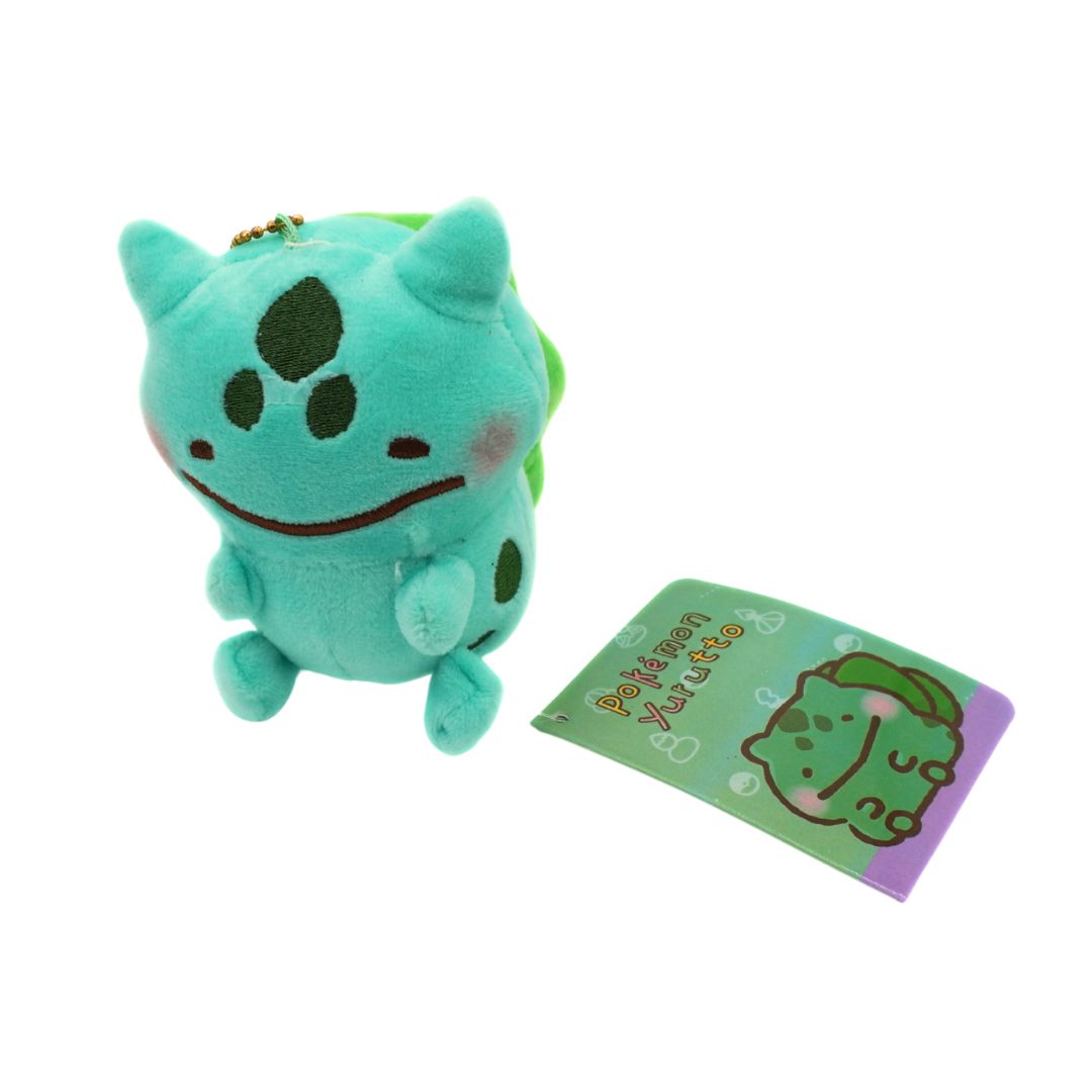 Plush toy with a Poké Ball keychain and Poké Ball Plus card on a white background